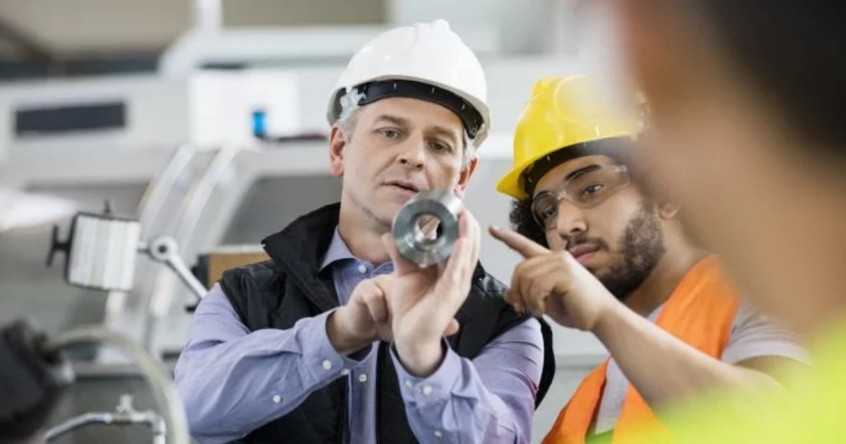 Engineers inspecting an aluminium component during quality control as part of OZBROS Quality Management service.